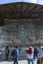 Tourists photograph the Last Judgment frescoes, Vorone? Monastery Church, 1547, Vorone?, Romania