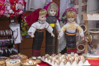 Dolls wearing traditional Romanian traditional costume at a stand, Vorone?, Romania