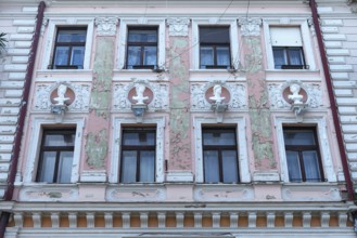 Dilapidated house façade with busts from Greek mythology, Czernowicz, Ukraine
