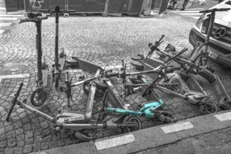 E-scooters thrown into the heap on the street after the e-scooter ban, black white, Paris, France