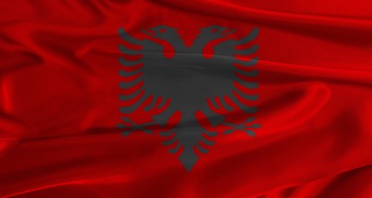 Flag of Albania with fabric textured background. Close up of National flag of Albania with