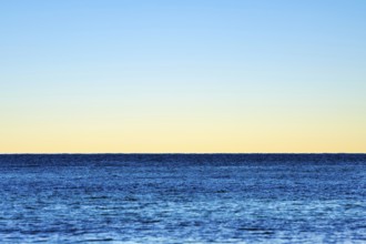 Minimalist illustration, horizon over the sea, clear evening sky, various shades of blue, calm