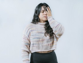 Exhausted young woman putting the palm on his face isolated. Tired and exhausted person covering