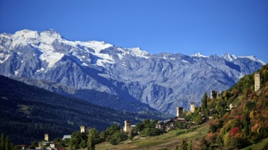 Snow-capped mountains in the background of villages in autumn landscape, Mestia, Georgia