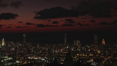 City view at night with illuminated buildings and dark sky, Batumi, Georgia