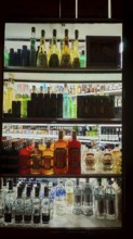Bottles of various spirits on an illuminated shelf, Prague, Czech Republic