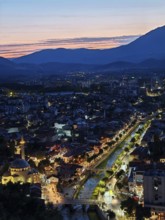 Nighttime city view with illuminated river and adjacent architecture, Prizren, Kosovo