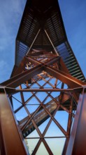 View of a metallic observation tower with geometric shapes under a blue sky, Pressecker Knock,