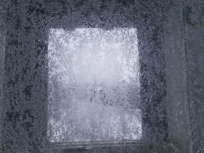 An icy window with frosty structures that give off a cold winter feeling, Franconian Forest nature