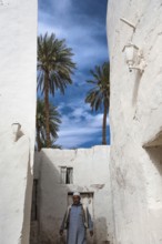 Ghadamis, Libya, North Africa. A bedouin walking through the whitewashed houses built traditionally