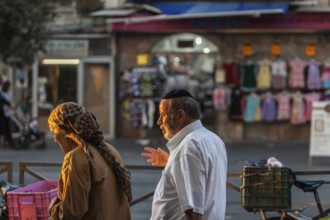 Jerusalem, Israel, Middle East. A couple walking in the Mea Sharim district in Jerusalem