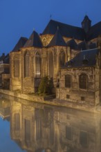 Ghent, Belgium, Flanders. A historic church with reflections in a canal