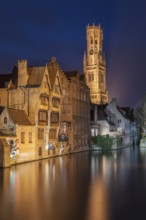 Bruges. Belgium. Flanders. Historic Houses and Town Hall tower in the old district overlooking a