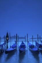 Venice, Veneto, Italy. Gondolas on the bacino di San Marco with San Giorgio Maggiore in the