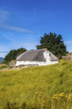 Isle of Skye, Scotland, UK. A traditional house across the meadows