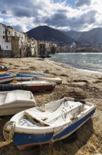 Traditional fishing boats on the shore, La Rocca mountain, Tyrrhenian Sea, Cefalu, Cefalù, Sicily,