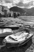 Traditional fishing boats on the shore, La Rocca mountain, monochrome, Tyrrhenian Sea, Cefalu,