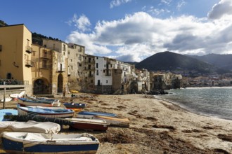 Traditional fishing boats on the shore, La Rocca mountain, Tyrrhenian Sea, Cefalu, Cefalù, Sicily,