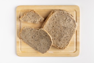 Wooden board with several slices of bread