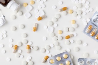 Different tablets and blister packs on a bright background