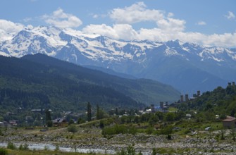 Mountain landscape with snow-capped peaks and a small village in the valley, Mestia, Mingrelia and