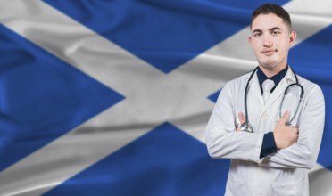 Portrait of medical professional on Scotland flag background. Scottish national health system