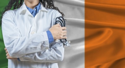Healthcare professional with Ireland flag background. Professional doctor holding stethoscope on