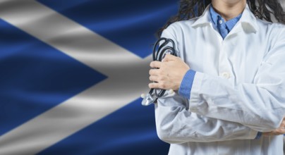Healthcare professional with Scotland flag background. Professional doctor holding stethoscope on