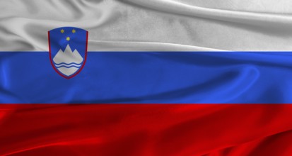 Flag of Slovenia with fabric textured background. Close up of National flag of Slovenia with