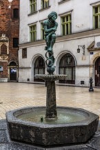 Fountain with student statue in historic clothing, Krakow, Poland