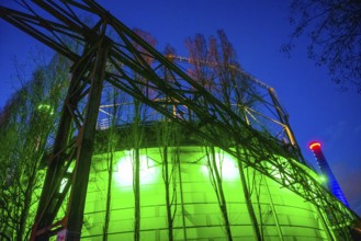 Industrial building illuminated at night in green with steel structures, Landschaftspark Duisburg