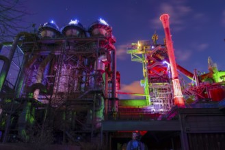 Industrial plant illuminated in colorful lights at night, Landschaftspark Duisburg Nord, Duisburg,