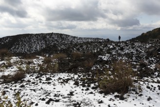 Barren volcanic landscape with remnants of snow, hikers, Etna, Etna, Catania, Sicily, Italy