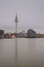 View across a harbor basin to the radar tower in Bremerhaven, Bremen, Germany