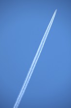 Airliner with contrails on blue sky, Bavaria, Germany