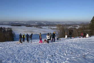 Tobogganing fun on a snow hill, Tauchersreuth, Middle Franconia, Bavaria, Germany