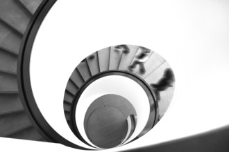 Spiral staircase with descending persons, black and white, Bavaria, Germany