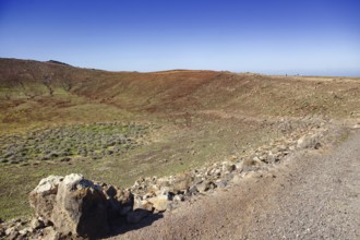 Wide landscape with partial view of the crater and dry soil under blue sky, Playa Blanca Lanzarote