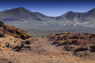 Volcanic landscape with mountains and eroded soil under blue sky, Playa Blanca Lanzarote