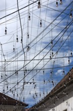 Light bulbs for evening lighting between houses, Cluj-Napoca, Romania