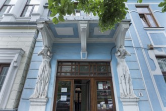 Caryatids under a balcony of a 19th century house, Cluj-Napoca, Transylvania, Romania