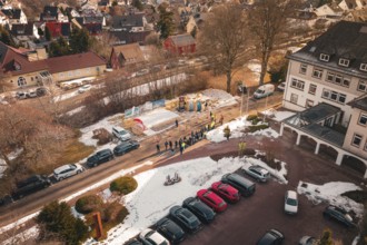 Aerial view of a people meeting on a snow-covered street and parking lot, fiberglass