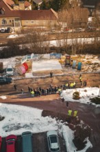 Gathering of people on a snowy road, watched from the air, fiberglass groundbreaking, Freudenstadt,