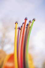 Close-up of colorful cables rising into the sky in sunshine, fiberglass groundbreaking,
