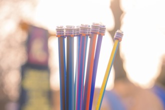 Colourful pipes rise up towards the sky in sunlight in a contrasting open-air environment,