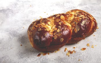 Braided, sweet bread pie, with sliced almonds, breakfast, braided bread, brioche, on a light