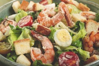 Caesar salad, with tiger prawns, shrimp salad, lettuce, quail eggs, cherry tomatoes, parmesan
