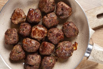 Fried meatballs in a frying pan, homemade, no people