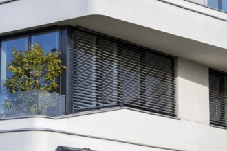 Modern blinds or modern external blinds on the window of a new residential building