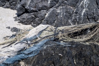 Close-up view of old fishing nets lying on the beach, Oman